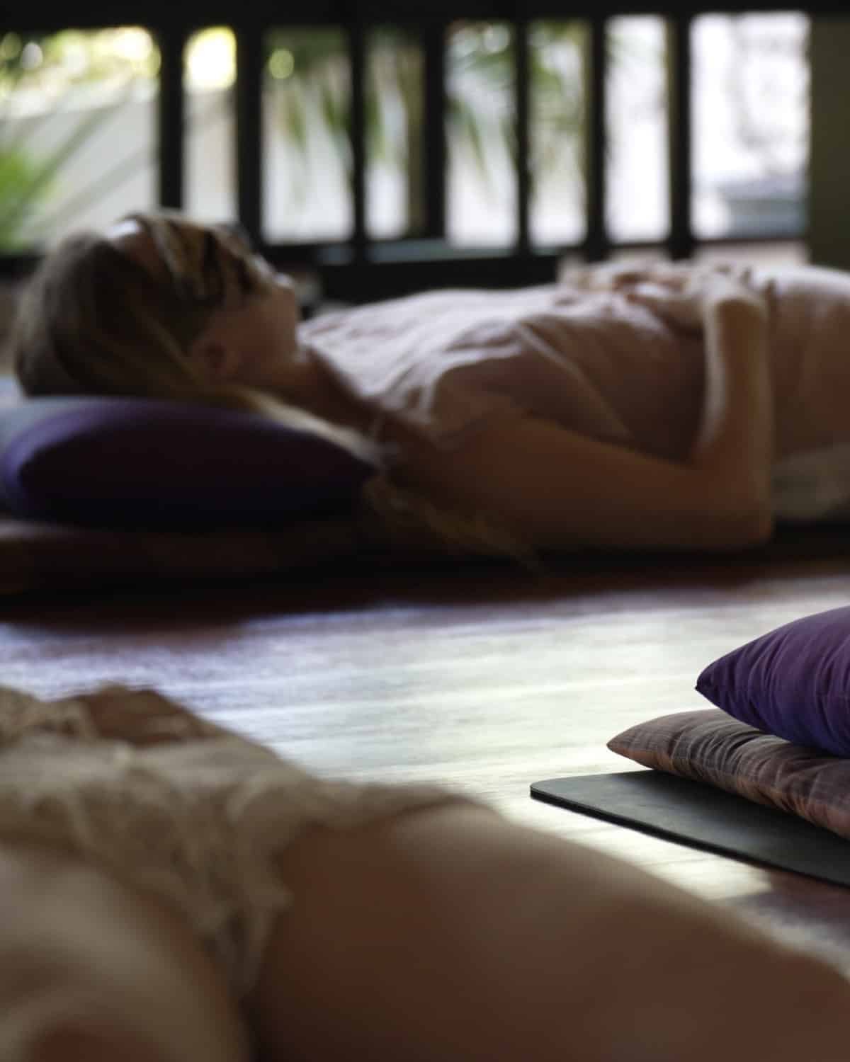 Guests resting on cushions in the open-air shala